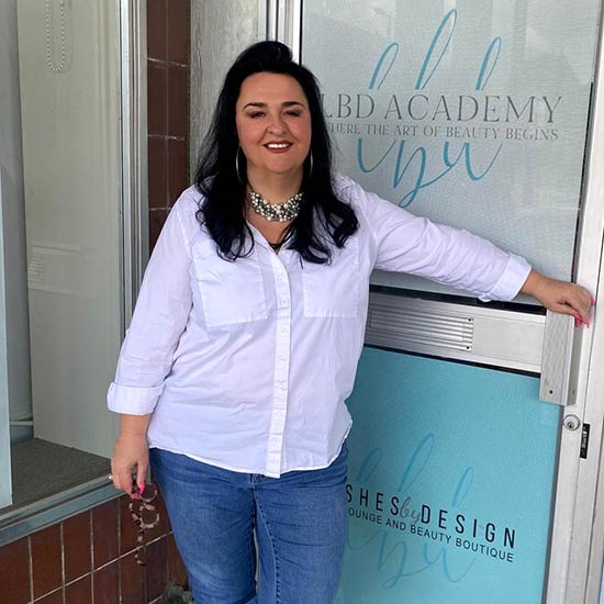 Kim at the front door of Lashes by Design